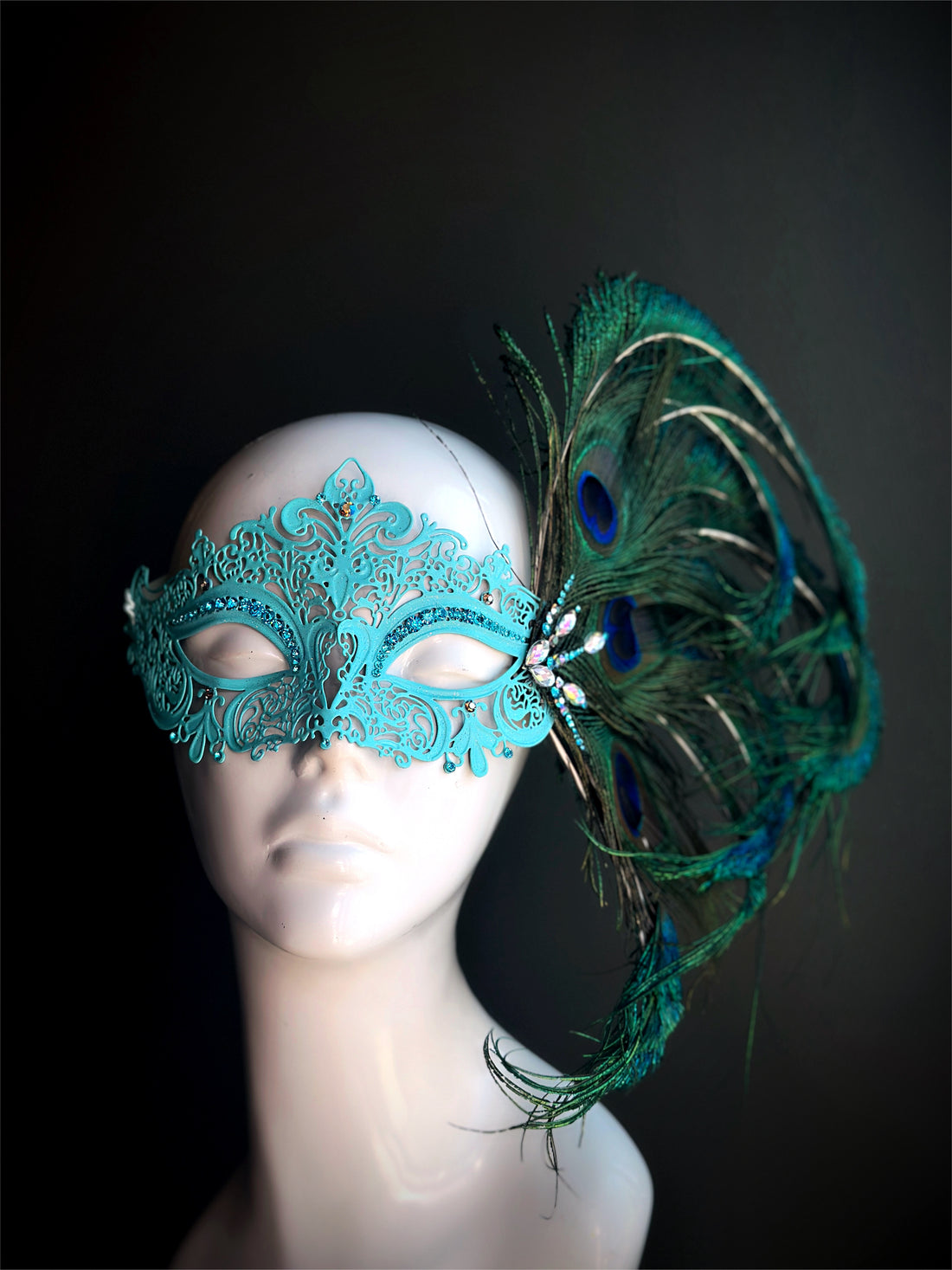 Peacock feather masquerade mask in turquoise filigree design for women’s prom, gala, or themed party looks