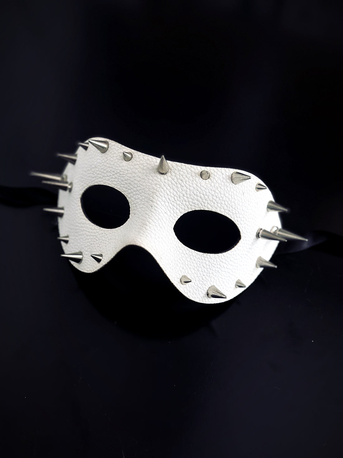 White pleather masquerade mask with silver spikes.