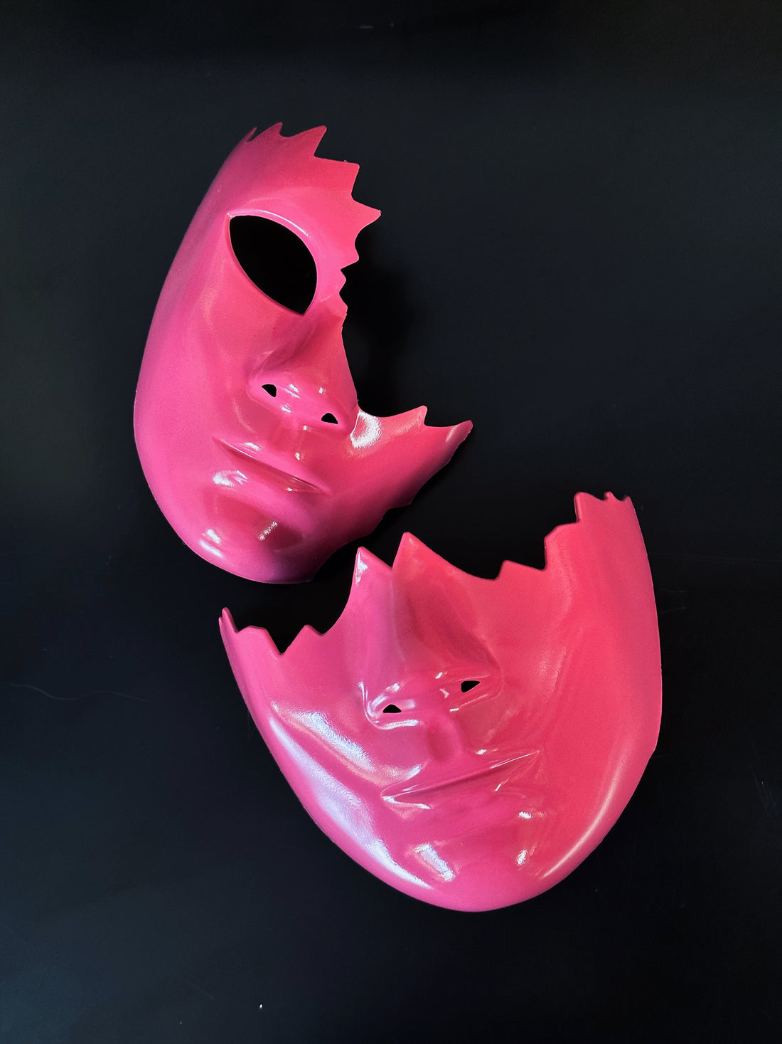 Glossy pink broken-face Venetian mask with mouth-only sculpt design
