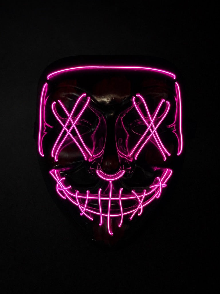 Pink Voltage LED light-up mask with glowing pink X eyes, stitched smile design, full-face shape, replaceable battery, and three lighting settings.