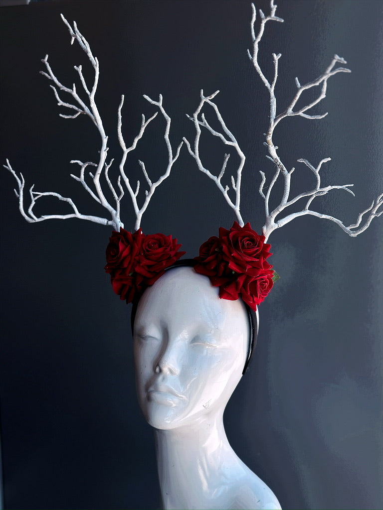 White antler crown with red crimson roses, perfect for woodland fairytale costumes and masquerade styling.