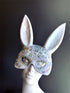 Sparkly white bunny ear masquerade mask with rhinestones and holographic gems, ideal for parties, raves, and masquerade balls.