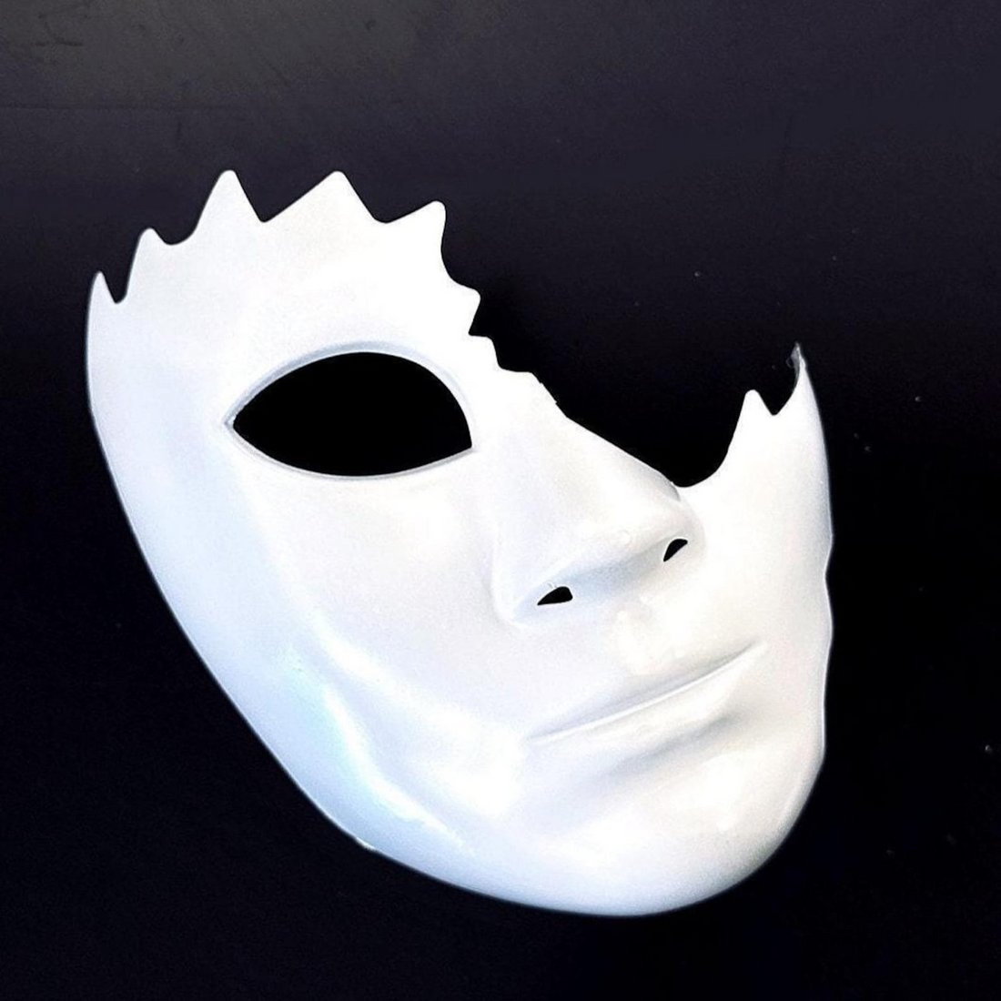 White cracked half-face phantom masquerade mask with jagged edge design for Halloween, opera, and cosplay.