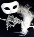 Elegant white Venetian couples masquerade masks featuring a simple satin mask for men and a lace mask with feathers and floral accents for women, perfect for weddings and formal events.

