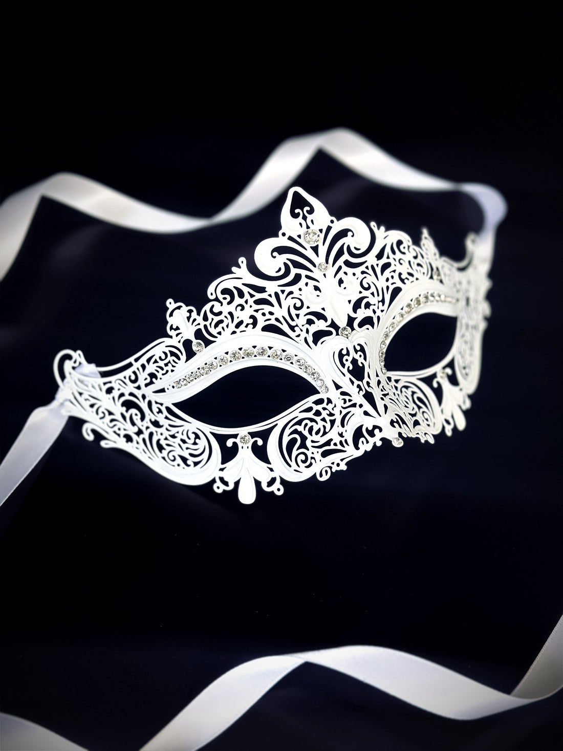 Elegant white masquerade mask with intricate lace-style design and soft ribbon straps for formal events or weddings