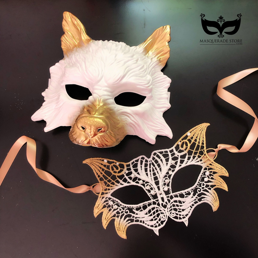 White and gold wolf masquerade mask paired with gold-trimmed lace mask for couples.