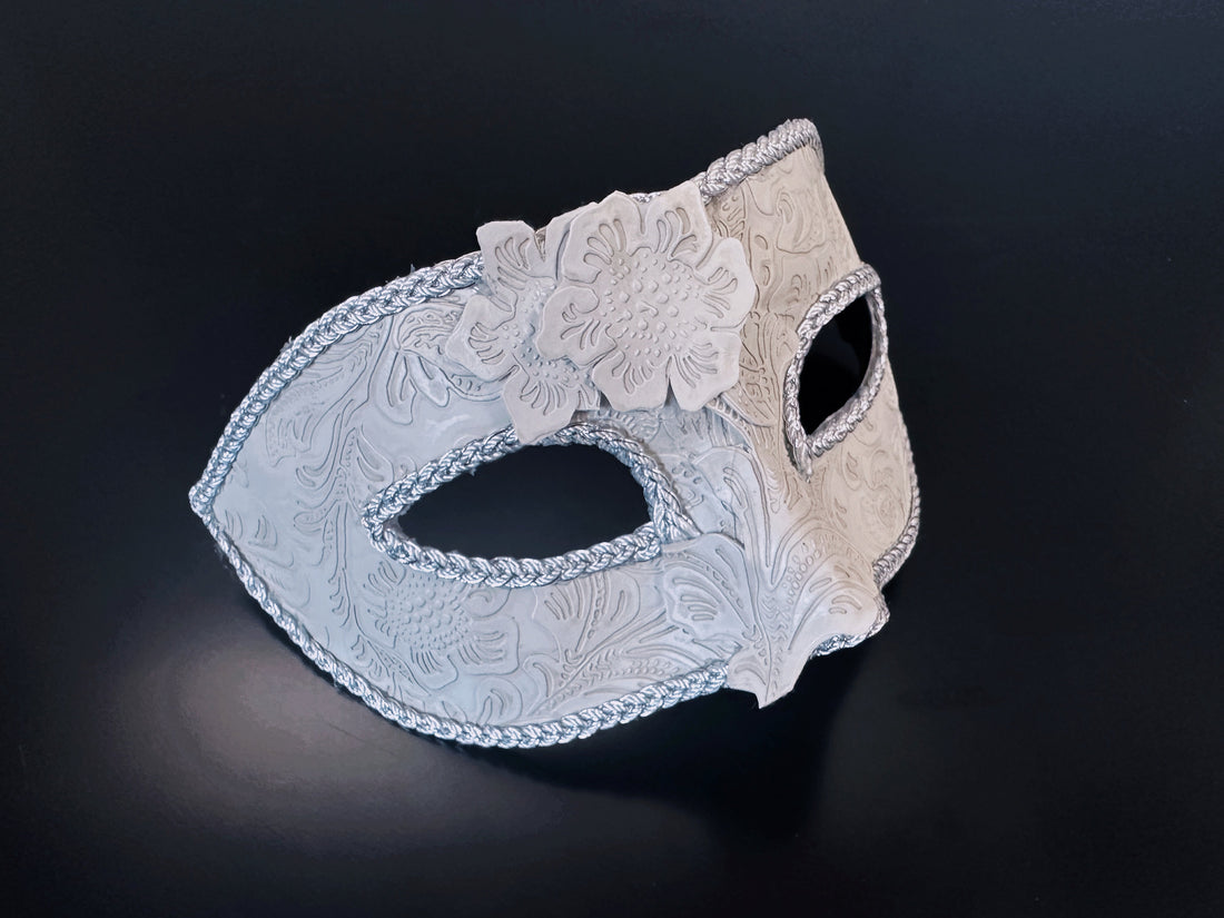 Elegant white masquerade mask with floral lace applique and beaded edges, ideal for formal male masquerade looks.