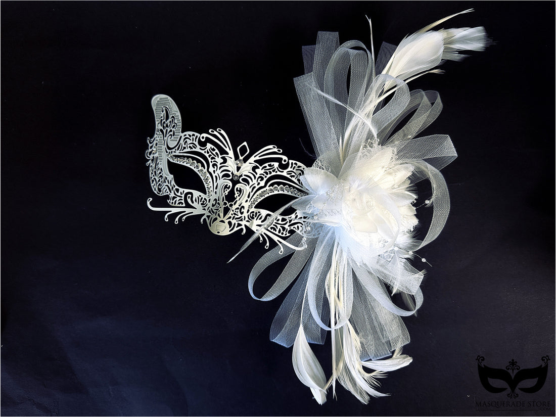 White lace masquerade mask with feathers, tulle, and flower accents for weddings and masquerade parties