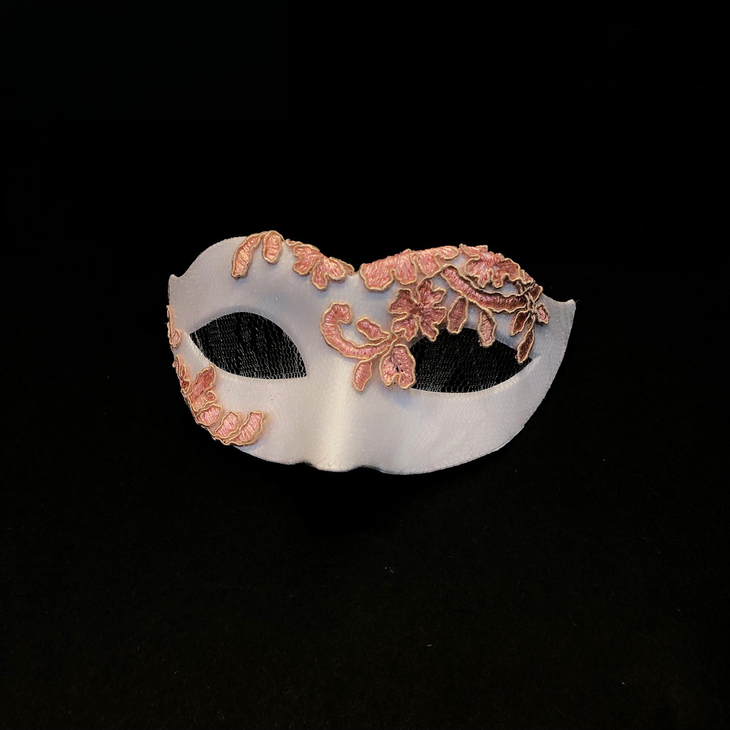 White masquerade mask with blush-pink floral lace applique.
