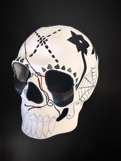 Minimalist sugar skull mask with black floral, web, and symbolic accents for Halloween or cultural wear