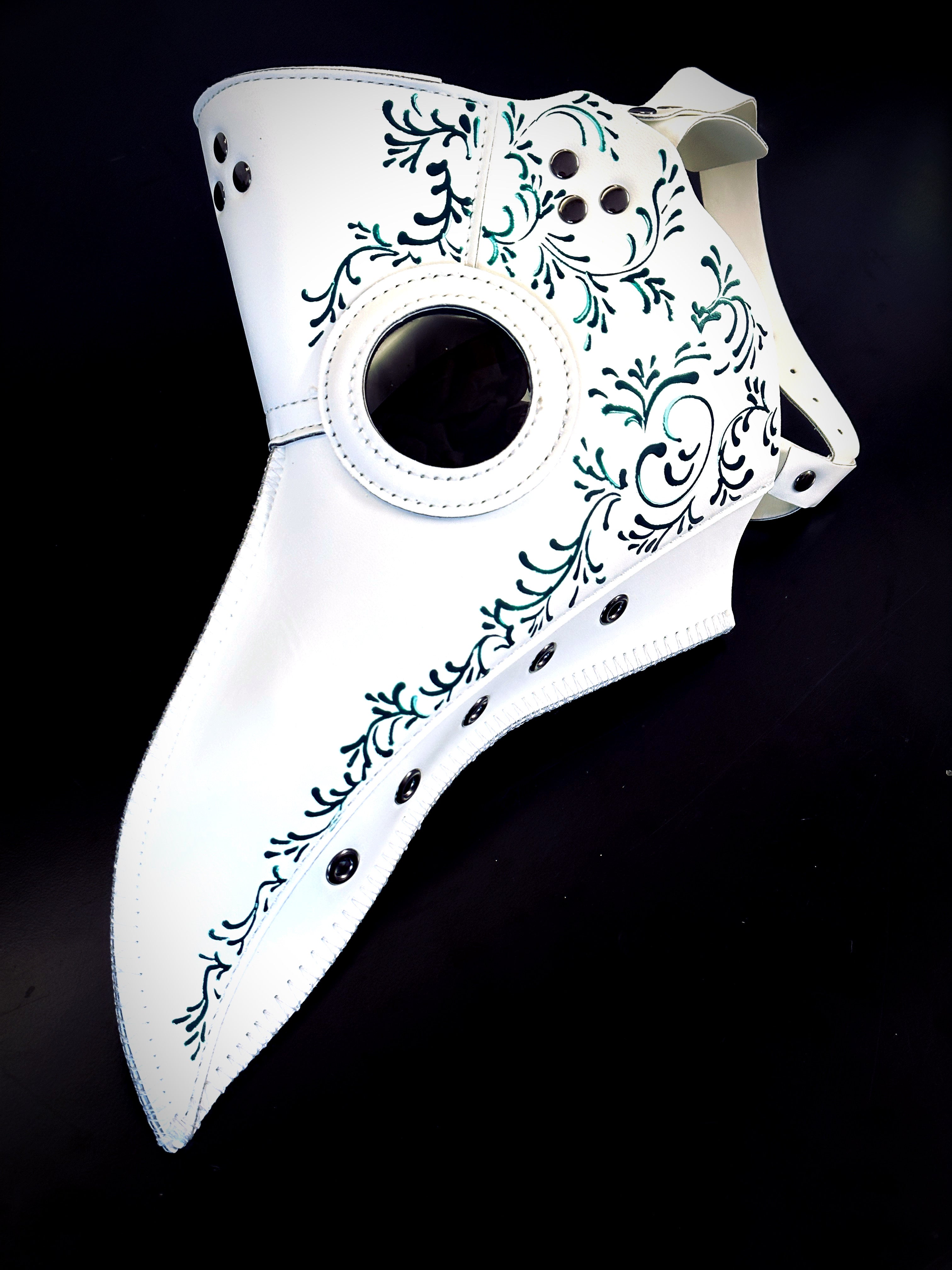 White plague mask with green filigree for sale.