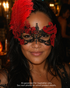 Crimson Plume red and black lace masquerade mask with embroidered floral details, tall red feather plume, openwork lace, and gothic event styling.