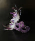 Purple feather masquerade mask with ornate resin half mask for formal masquerade occasions.