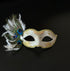 White masquerade women mask  with gold detail and peacock feathers for elegant formal events.