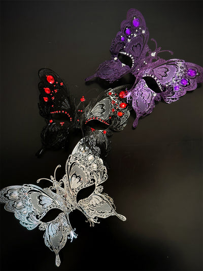 Women's metal butterfly masquerade mask with rhinestones. Available in purple, black, and silver.
