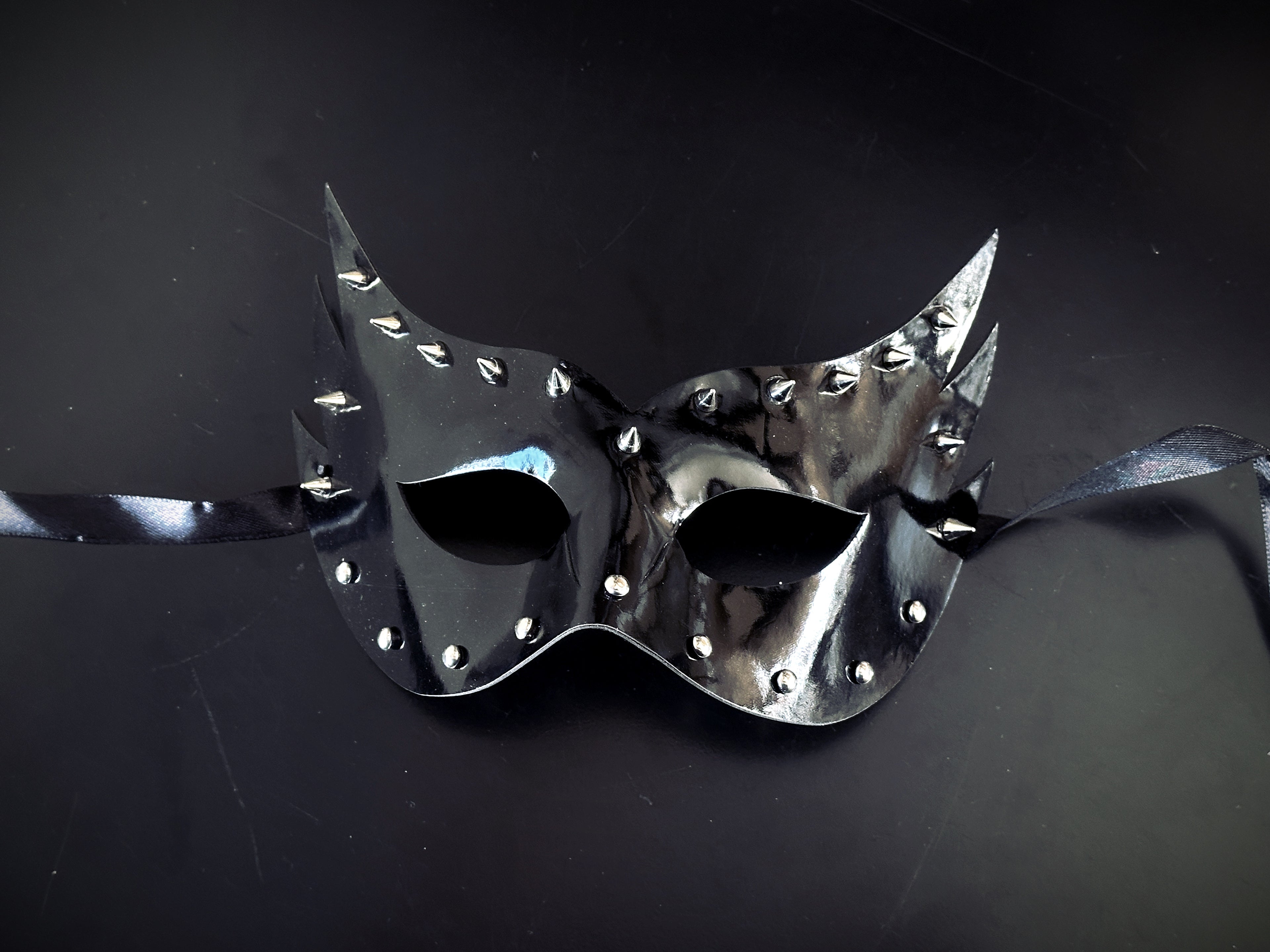 Black pleather masquerade mask with silver studs and spikes.