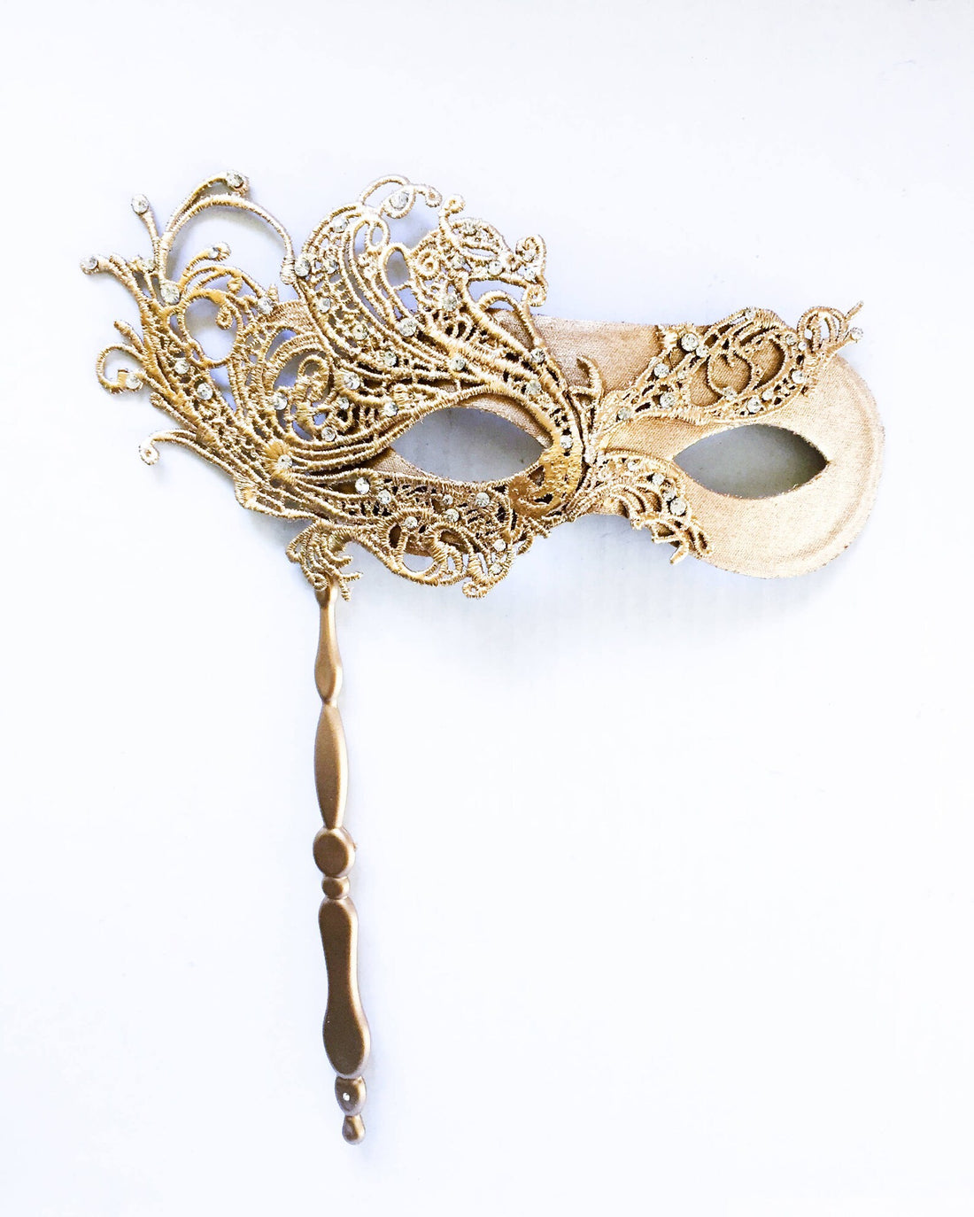 Womens masquerade mask on a handheld stick in gold.