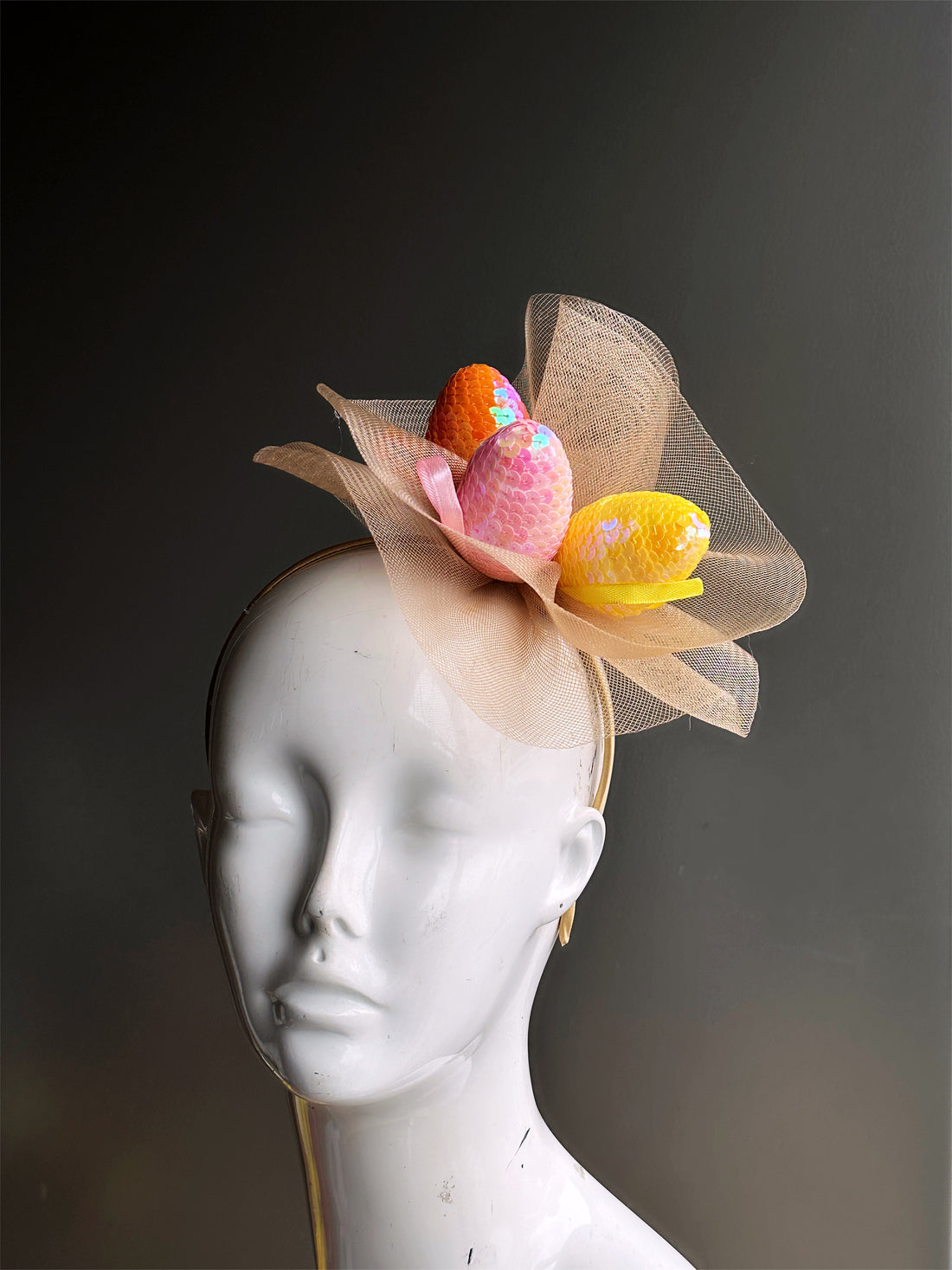 Headband with gold tulle and sequin easter eggs in orange, pink, and yellow.