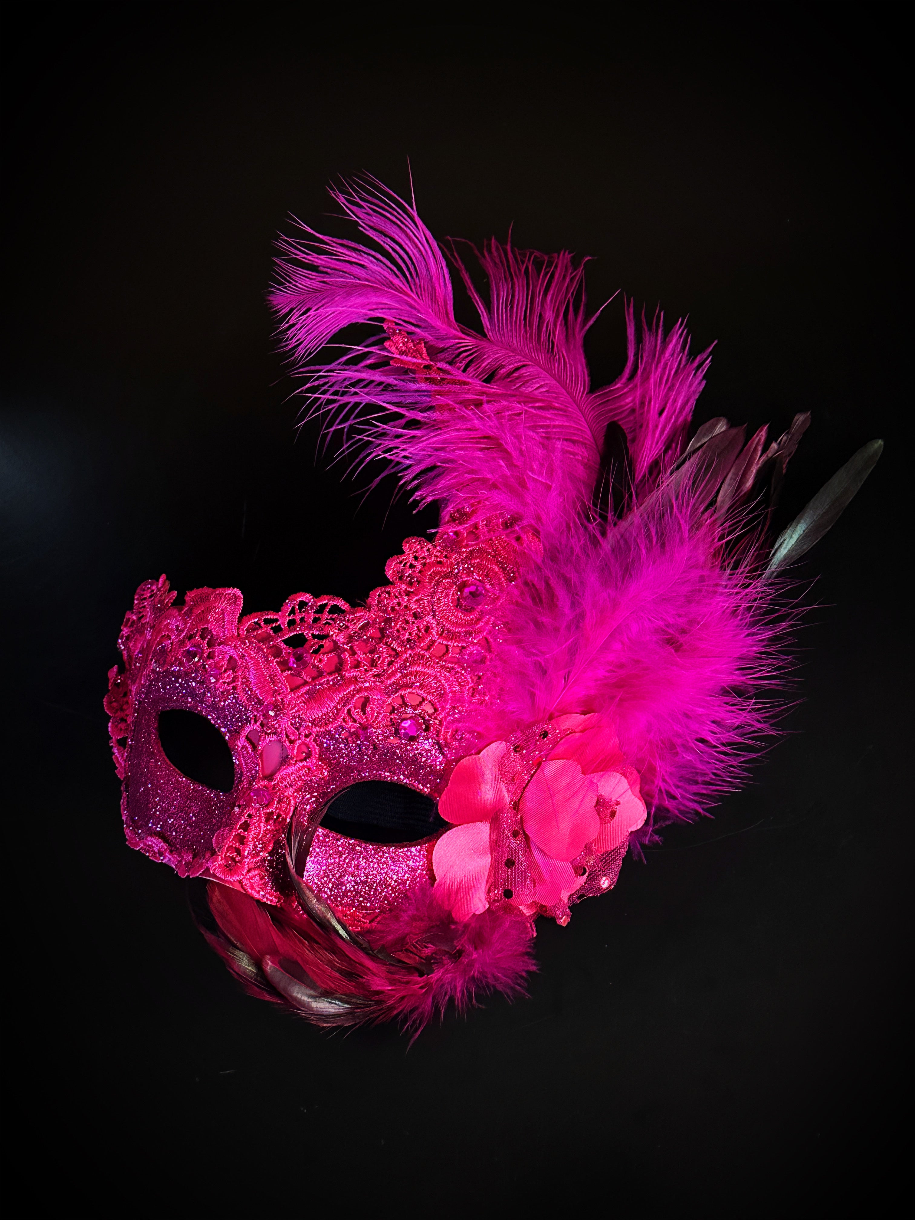 Womens masquerade mask in hot pink with pink feathers.