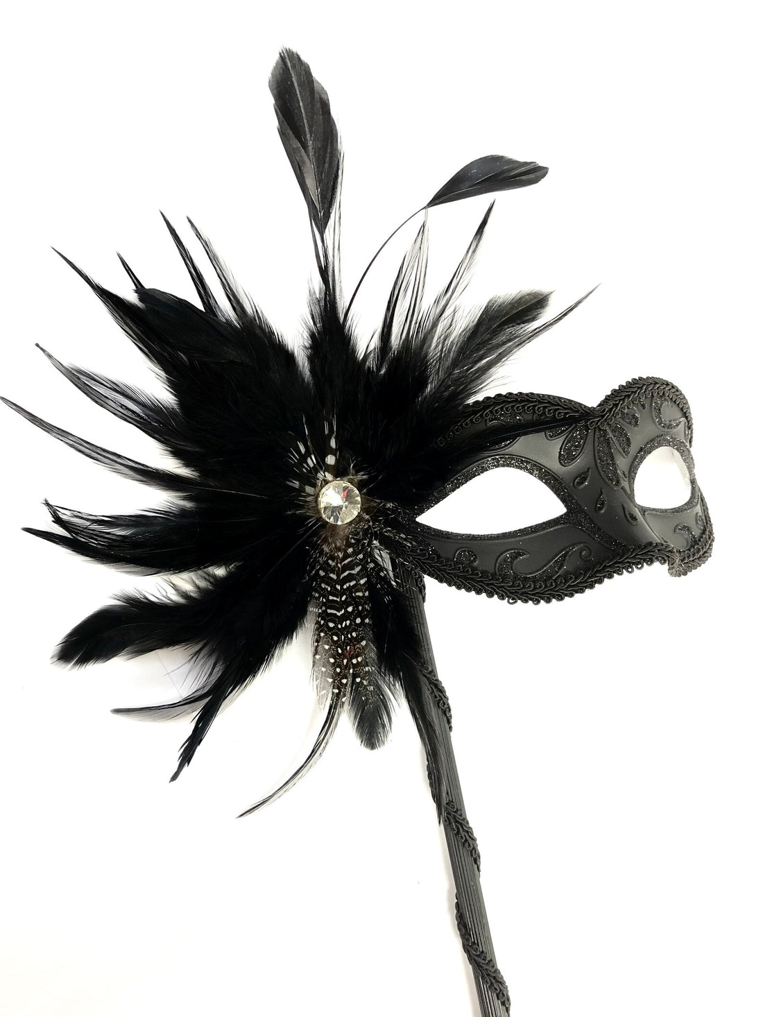 Womens masquerade mask on a handheld stick with feathers for sale.