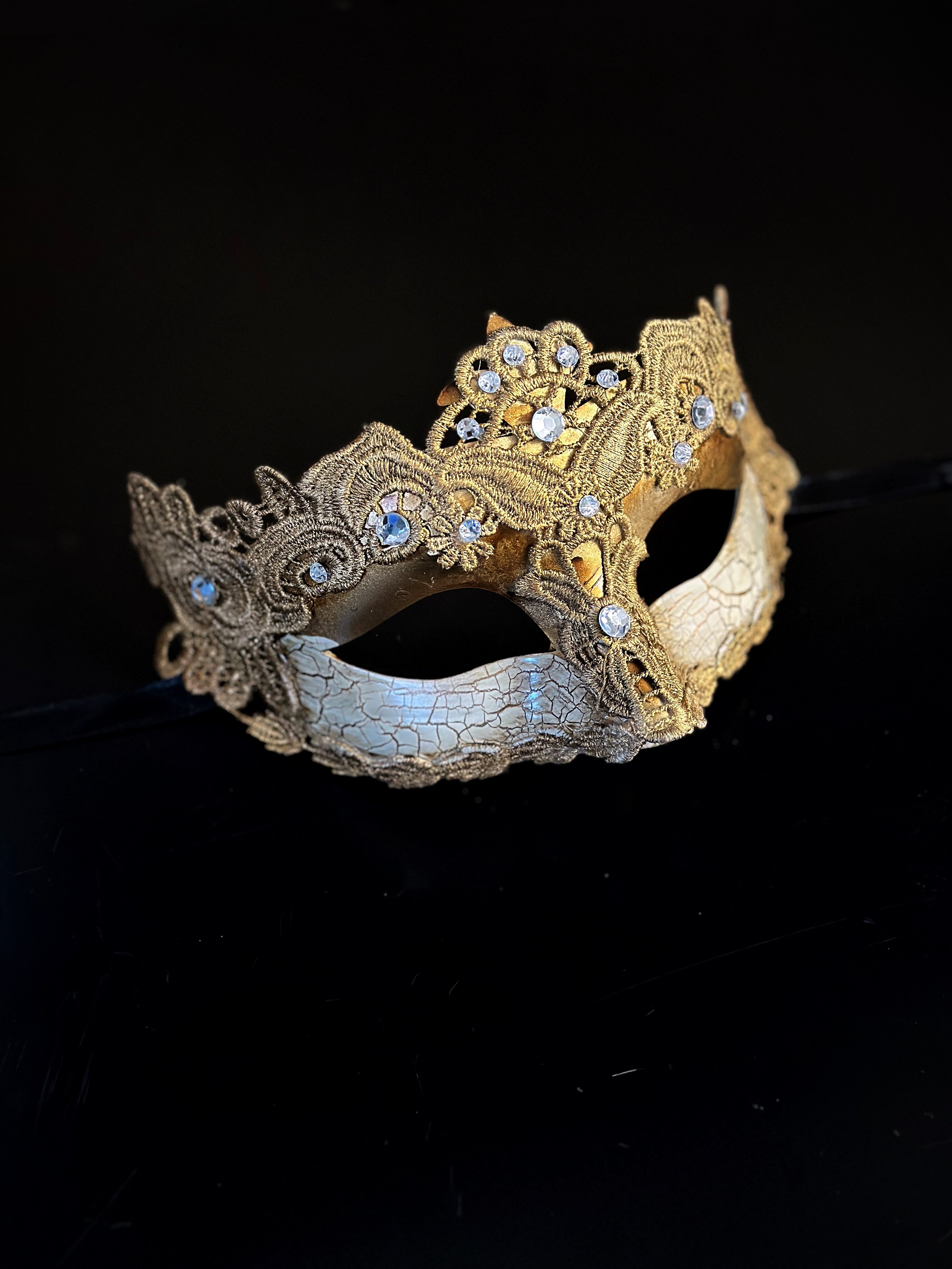 Womens masquerade mask in gold with a cracked lace brocade style.