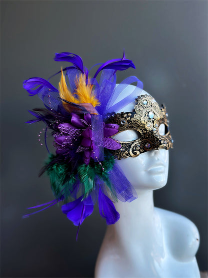 Womens masquerade mask in gold with purple gold green feathers for mardi gras.