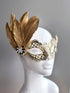 Womens masquerade laser cut metal mask in gold with gold feathers for sale.