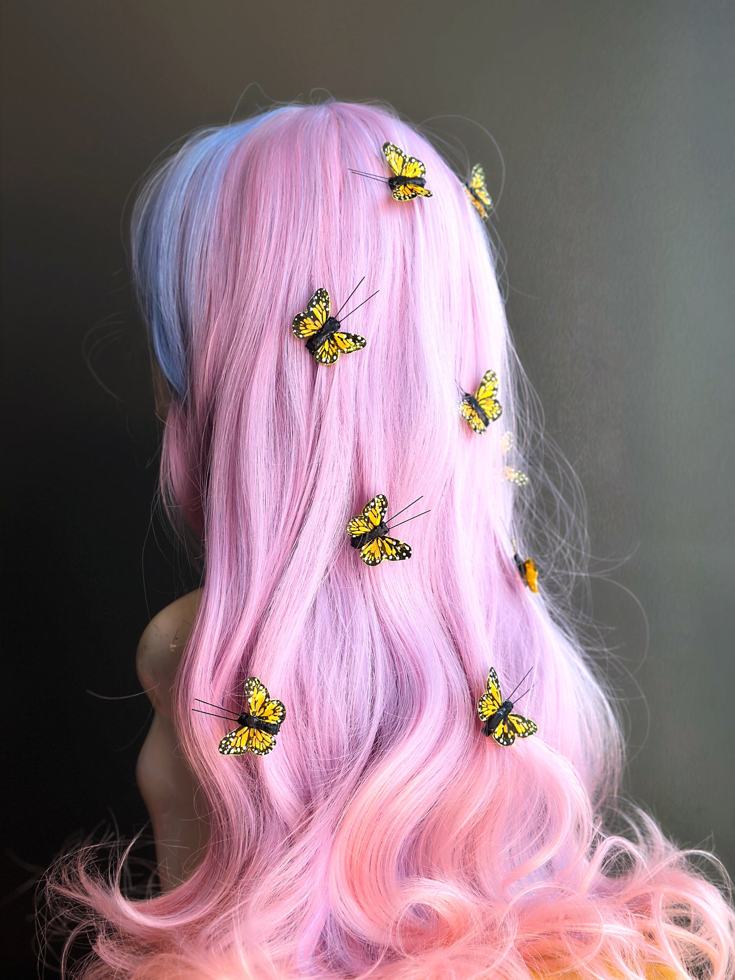 Bright yellow butterfly clips in pastel wavy hair for whimsical styling