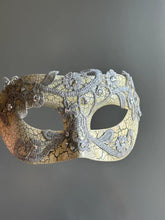 Side view of antique crackle Venetian masquerade mask with silver lace and rhinestone accents.