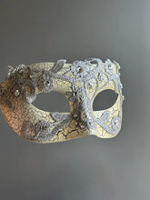 Side view of antique crackle Venetian masquerade mask with silver lace and rhinestone accents.