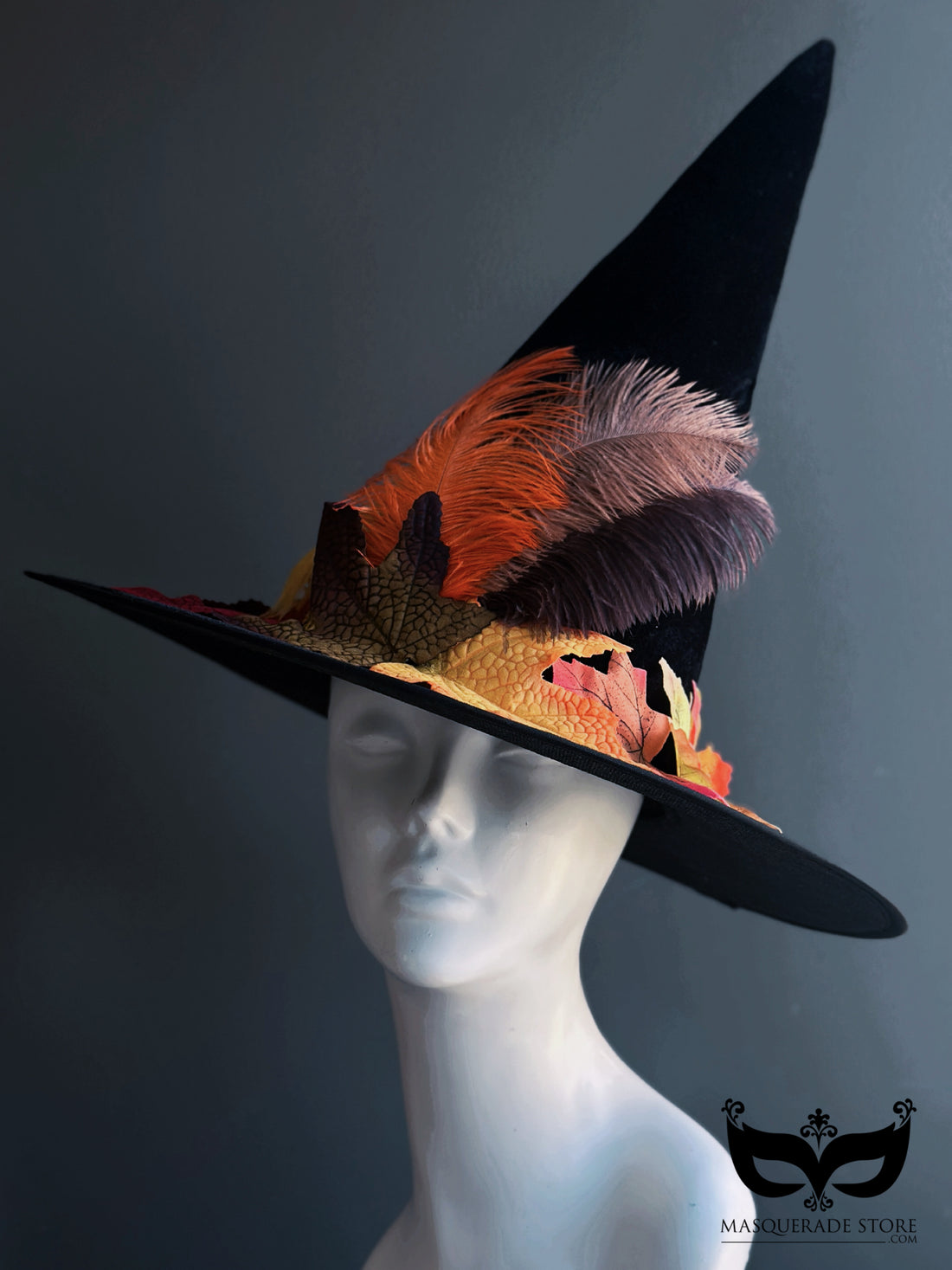 Black witch hat with multicolor fall leaves and feathers—autumn festival or Halloween-ready.