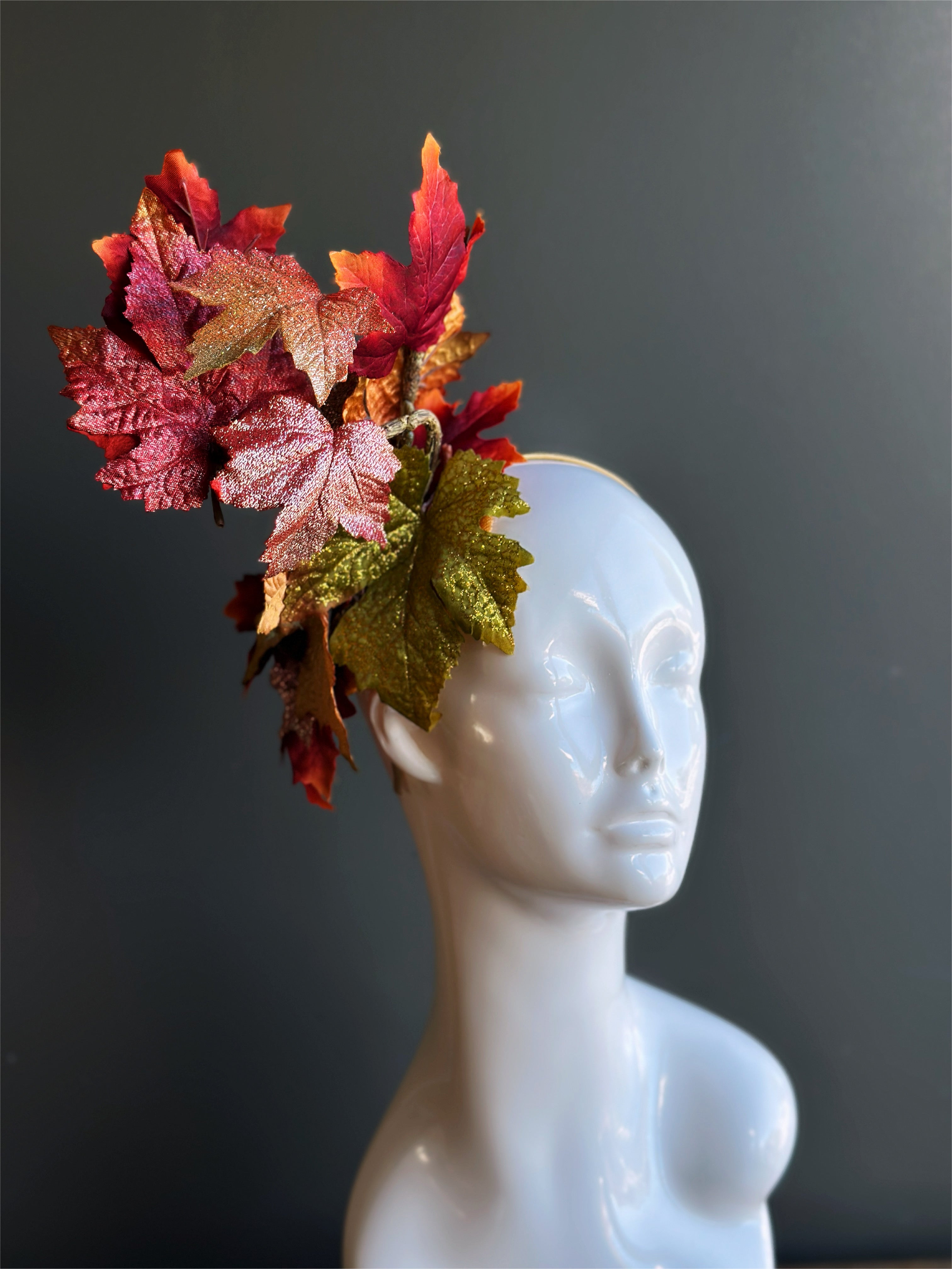 Autumn leaf fascinator hat with glittered red and gold leaves for fall.