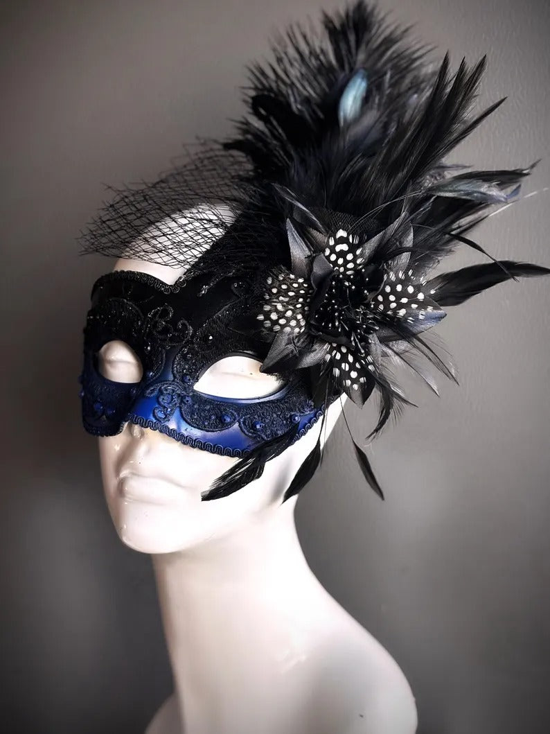 Elegant masquerade mask in black and blue with feathers, rhinestones, and veil for carnival, prom, and masquerade ball.