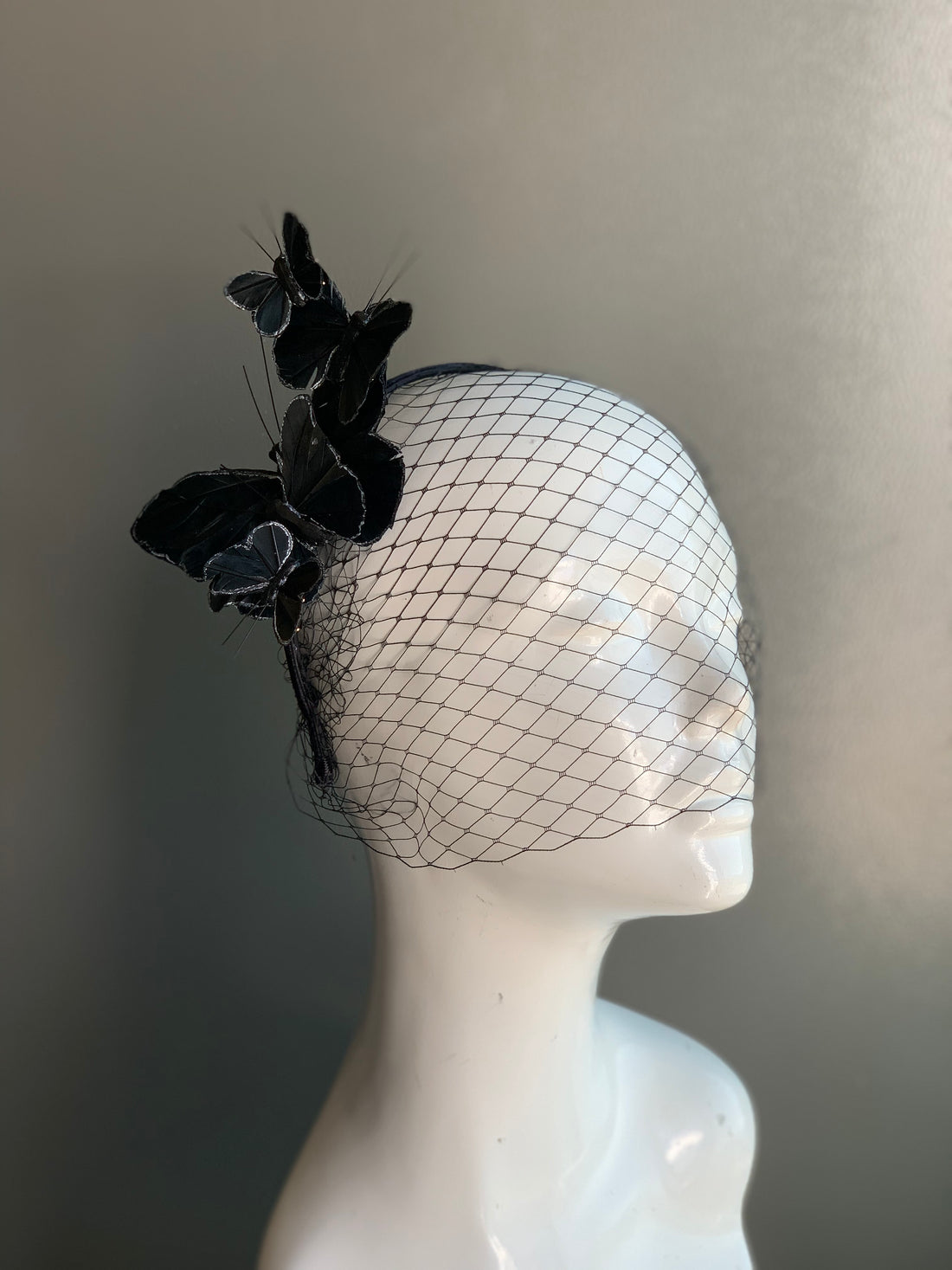 Black butterfly veil fascinator with netted design, ideal for gothic and vintage styling.