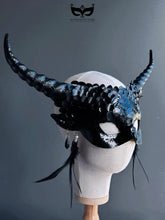 Fantasy black dragon masquerade mask with curled horns and feathers.