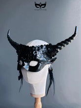 Fantasy black dragon masquerade mask with curled horns and feathers.