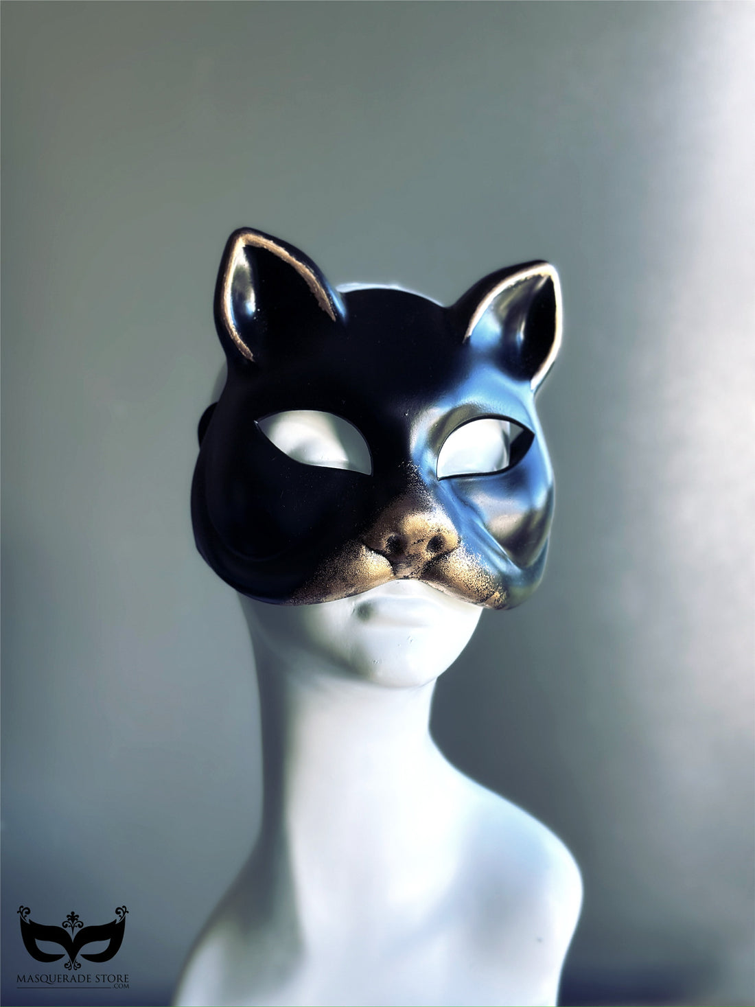 Glossy black and gold cat mask with sculpted ears and gold muzzle for Halloween masquerade costume