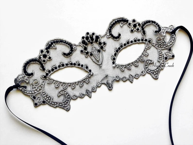 Elegant black lace masquerade mask with rhinestone details for women’s prom, ball, or party.