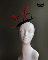 Black fascinator hat with red sculpted loops
