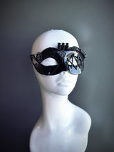 Black steampunk masquerade mask for women with intricate gear details and industrial-inspired design, displayed on a mannequin head.

