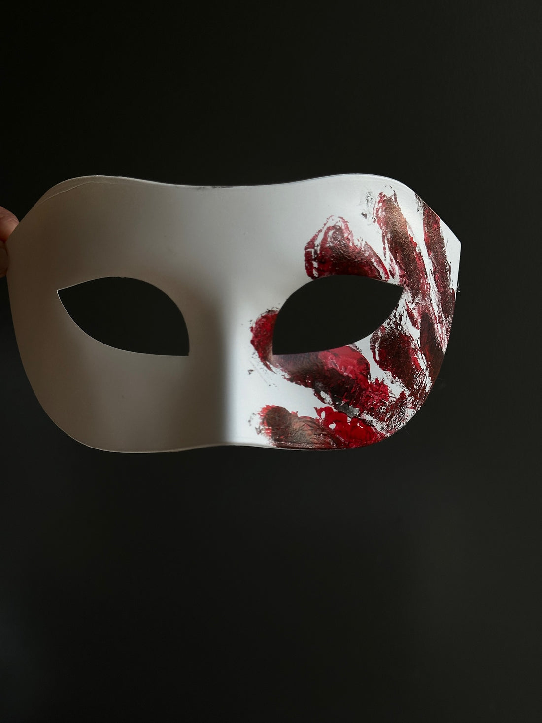 White masquerade-style horror mask with red bloody handprint design, perfect for scary costumes or haunted house actors
