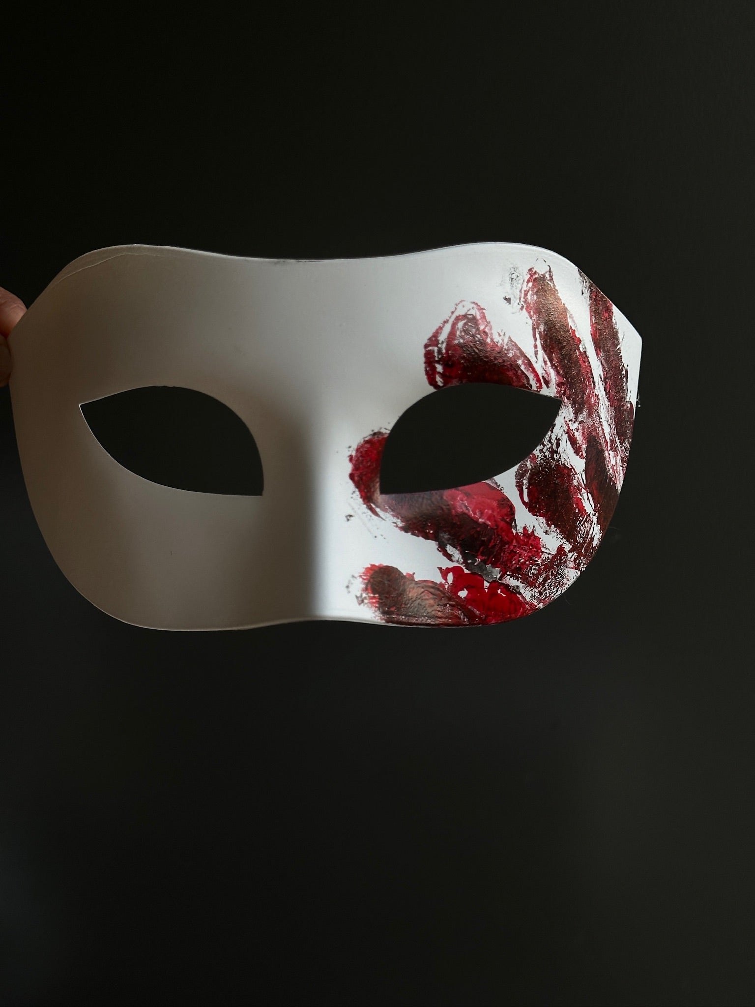 White masquerade-style horror mask with red bloody handprint design, perfect for scary costumes or haunted house actors