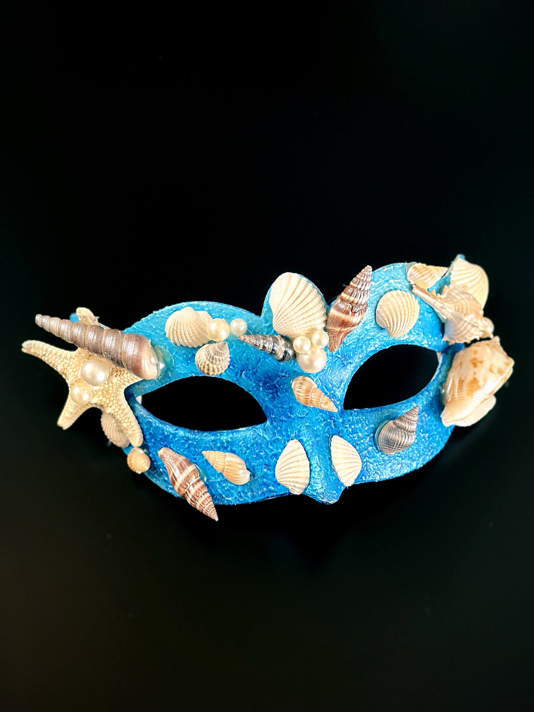 blue mermaid masquerade mask with pearls, starfish, and sea shells.