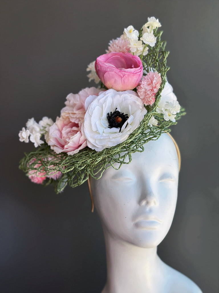 Blush pink and ivory floral fascinator featuring ranunculus flowers, delicate white blossoms, fresh greenery, sculptural open-weave sinamay, and a comfortable headband for Kentucky Derby, Royal Ascot, weddings, tea parties, church, Easter, and elegant garden parties.