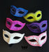 Bulk Venetian masquerade masks in assorted blue, yellow, pink, purple, and ivory colors featuring embossed scrollwork, glitter accents, and decorative trim for Mardi Gras, weddings, and party events.