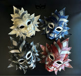 Bulk sculptural Venetian full-face masquerade masks featuring layered sunburst designs in gold, blue, black, and red for masquerade parties and theatrical events.