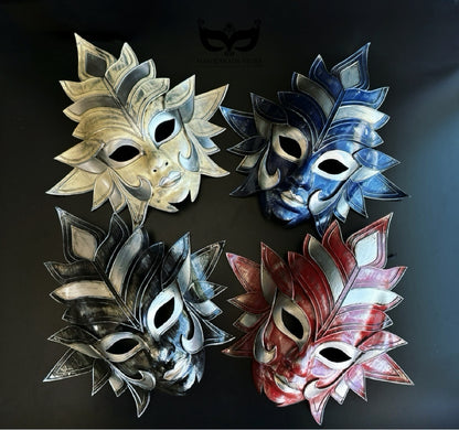 Bulk sculptural Venetian full-face masquerade masks featuring layered sunburst designs in gold, blue, black, and red for masquerade parties and theatrical events.