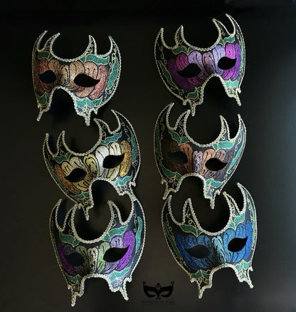Bulk Venetian crescent masquerade masks with floral artwork, ornate filigree detailing, and gothic-inspired silhouette in assorted jewel-tone colors.