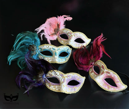 Bulk Venetian masquerade masks featuring decorative feather plumes, metallic finishes, glitter scrollwork, and elegant pastel color combinations.