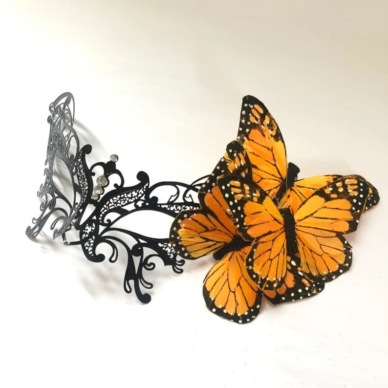 Black filigree masquerade mask with orange monarch butterflies for women.